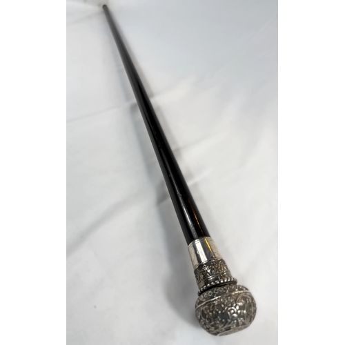 233 - A 19th Century walking stick with tapering ebonised shaft, the ornate white metal knop finial concea... 