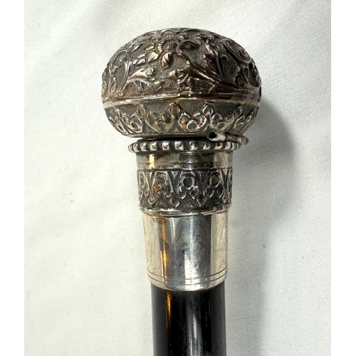 233 - A 19th Century walking stick with tapering ebonised shaft, the ornate white metal knop finial concea... 