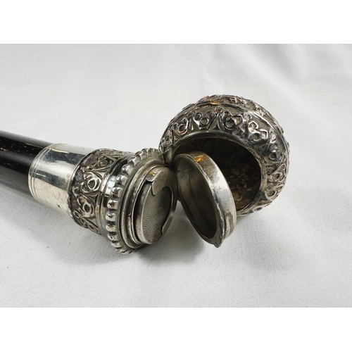 233 - A 19th Century walking stick with tapering ebonised shaft, the ornate white metal knop finial concea... 