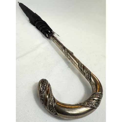 236 - An antique umbrella with spiral embossed silver loop handle, London, 1868, 90cm.