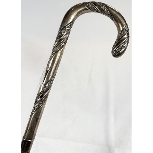 236 - An antique umbrella with spiral embossed silver loop handle, London, 1868, 90cm.