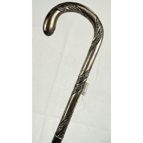 236 - An antique umbrella with spiral embossed silver loop handle, London, 1868, 90cm.