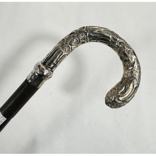 247 - An Edwardian period lady's stick with embossed silver mounted loop handle, London, 1907, 89cm.