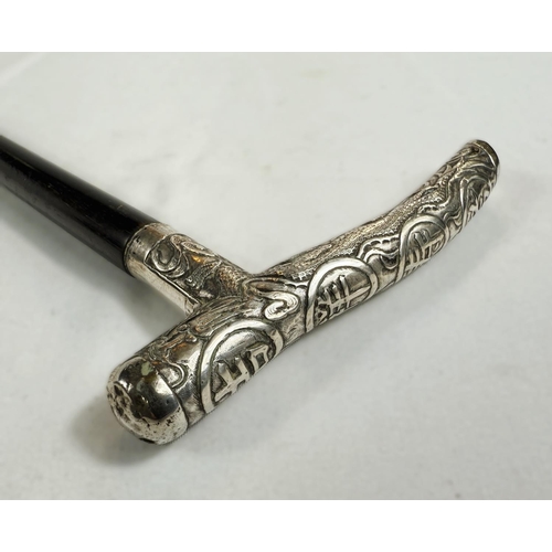 248 - A Chinese lady's ebonised walking stick with silver handle embossed with characters, 90cm.