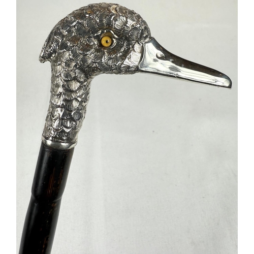 253 - A late Victorian lady's ebonised stick with silver band having vacant cartouche and silver bird's he... 