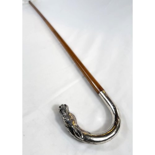 254 - An Edwardian cane riding stick with silver loop handle having horse's head finial and engraved 'Arth... 