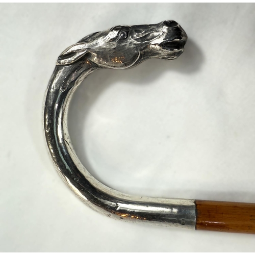 254 - An Edwardian cane riding stick with silver loop handle having horse's head finial and engraved 'Arth... 