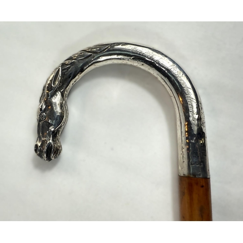 254 - An Edwardian cane riding stick with silver loop handle having horse's head finial and engraved 'Arth... 