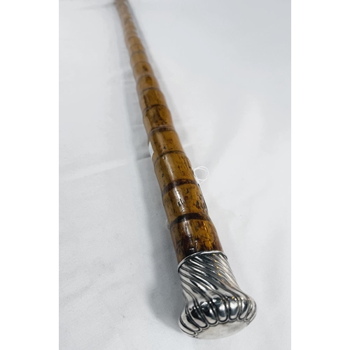 255 - An Edwardian heavy cane walking stick with silver gadrooned finial, London, 1910, 94cm.