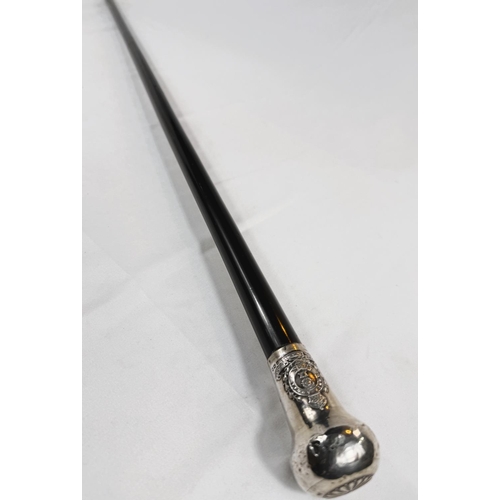 256 - An early 20th Century presentation stick with ebony shaft, the silver knop bearing the badge of the ... 