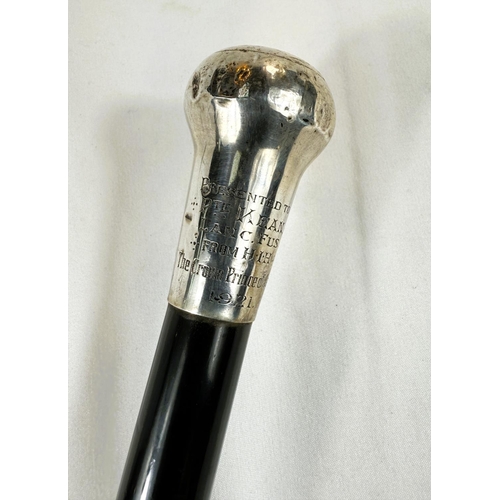 256 - An early 20th Century presentation stick with ebony shaft, the silver knop bearing the badge of the ... 