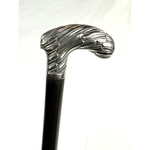 262 - A late Victorian ebonised walking stick with gadrooned handle stamped 'Brigg', London 1895, 88cm.