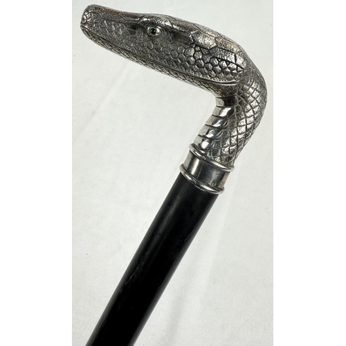 264 - A 19th Century continental ebonised walking stick with 800 standard silver snake's head handle inset... 