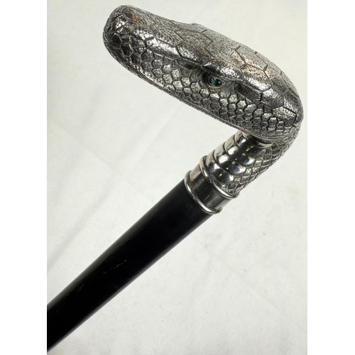 264 - A 19th Century continental ebonised walking stick with 800 standard silver snake's head handle inset... 