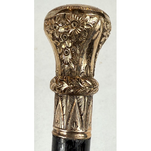 269 - A 19th Century ebonised walking stick with gilt metal floral engraved finial, 81cm.