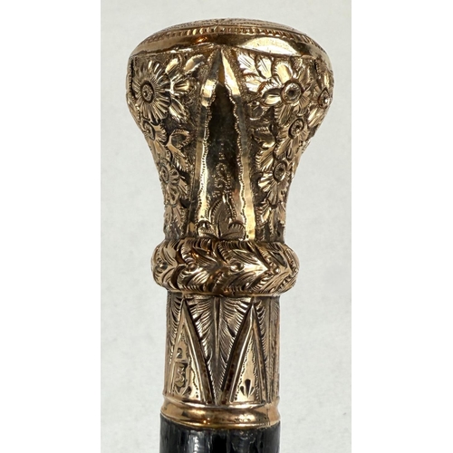 269 - A 19th Century ebonised walking stick with gilt metal floral engraved finial, 81cm.