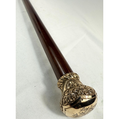 270 - A 19th Century hardwood walking stick with chased gilt metal cushion-shaped finial, 90cm.