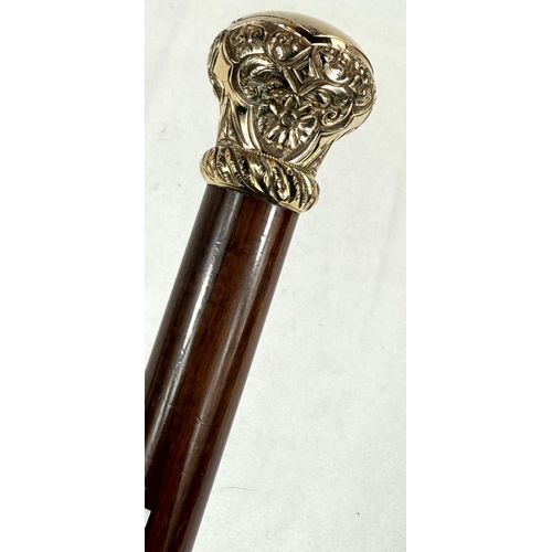 270 - A 19th Century hardwood walking stick with chased gilt metal cushion-shaped finial, 90cm.