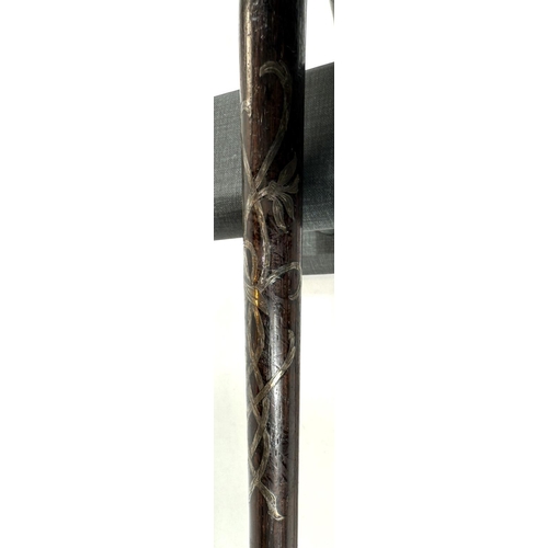 30 - An Edwardian ebonised walking stick with inlaid silver ribbon work and finial, 84cms, and two other ... 