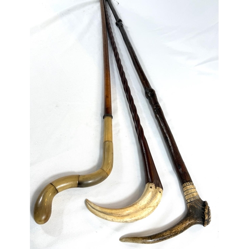 35 - A vintage stick with antler handle, 95cms, and two other sticks (3).