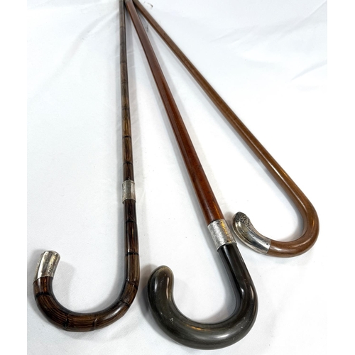 36 - A vintage Malacca cane walking stick with horn loop handle and silver mount, 95cm, and two others.