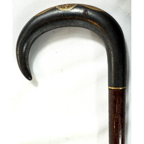 38 - An Edwardian slender hardwood stick with gilt inlaid steel handle, possibly Russian, 90cm.