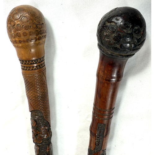 39 - A 19th Century Japanese bamboo walking cane with carved decoration of faunae, 89cm, and another with... 