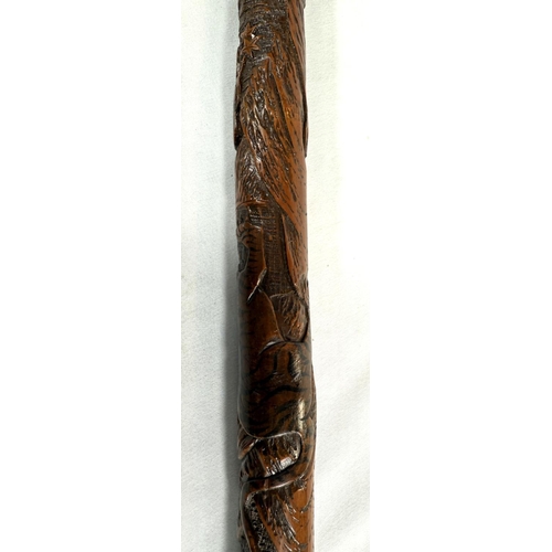 39 - A 19th Century Japanese bamboo walking cane with carved decoration of faunae, 89cm, and another with... 