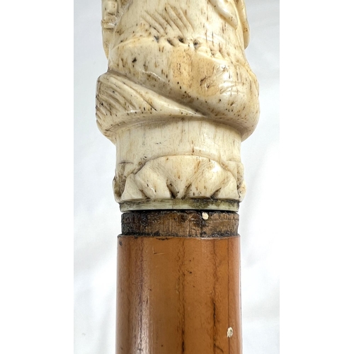 4 - A 19th Century ebony stick with carved ivory finial of a fierce dog, 89cms, and two other 19th Centu... 