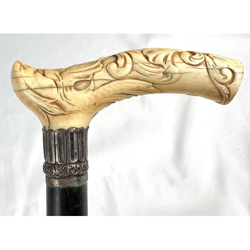 4 - A 19th Century ebony stick with carved ivory finial of a fierce dog, 89cms, and two other 19th Centu... 