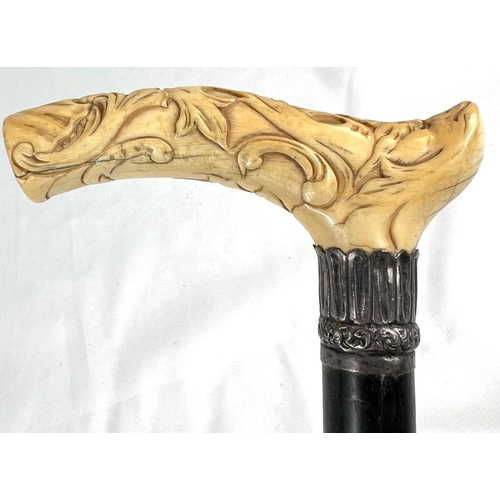 4 - A 19th Century ebony stick with carved ivory finial of a fierce dog, 89cms, and two other 19th Centu... 