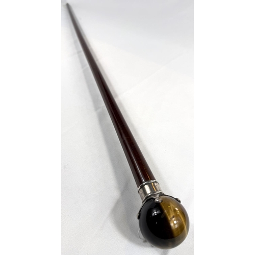 44 - A 19th Century hardwood walking cane with silver mounted spherical tiger's eye knob, 90cm.