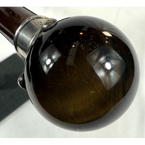 44 - A 19th Century hardwood walking cane with silver mounted spherical tiger's eye knob, 90cm.