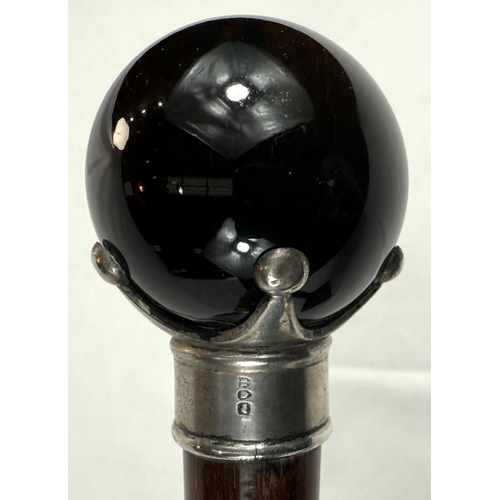 44 - A 19th Century hardwood walking cane with silver mounted spherical tiger's eye knob, 90cm.