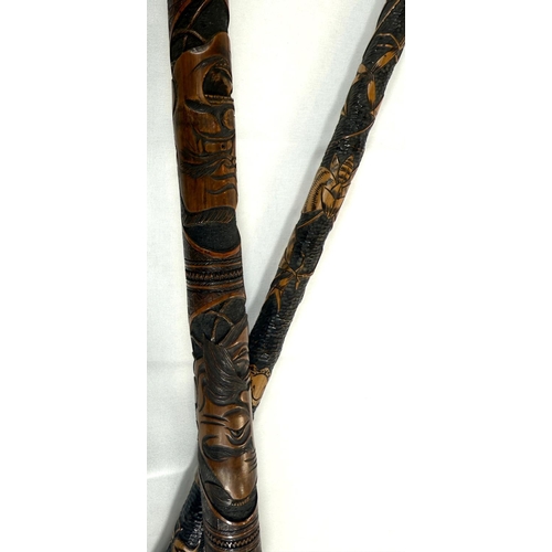 45 - A 19th Century Japanese carved bamboo walking cane decorated with theatrical masks, 89cm, and anothe... 