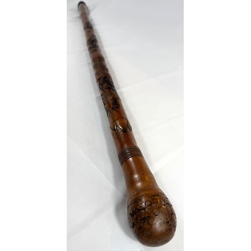 46 - A late 19th Century Japanese bamboo walking cane with carved naturalistic decoration, signed, 85cm.