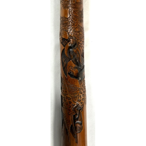 46 - A late 19th Century Japanese bamboo walking cane with carved naturalistic decoration, signed, 85cm.