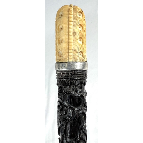 5 - A 19th Century ebonised stick with Japanese carved ivory handle and engraved silver band, 86cms, ano... 