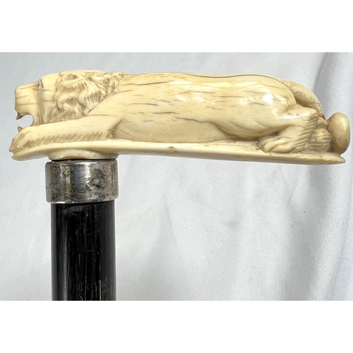 5 - A 19th Century ebonised stick with Japanese carved ivory handle and engraved silver band, 86cms, ano... 