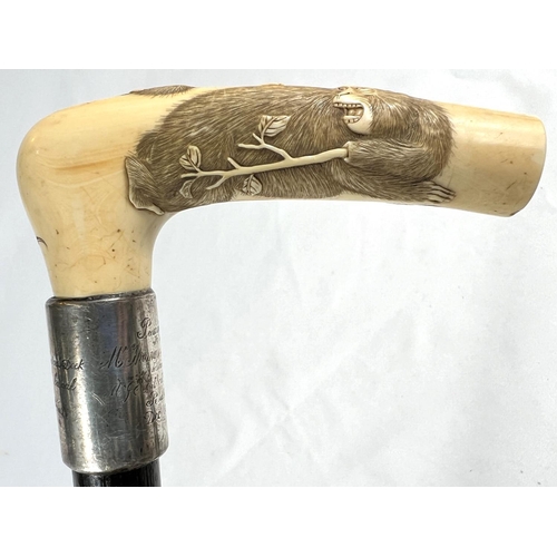 5 - A 19th Century ebonised stick with Japanese carved ivory handle and engraved silver band, 86cms, ano... 