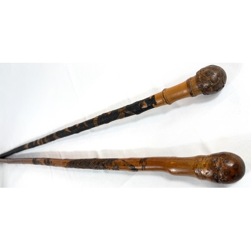 50 - A late 19th Century Japanese walking cane with carved decoration of insects, 88cm, and another (2).