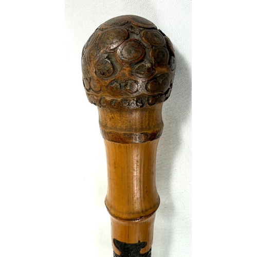 50 - A late 19th Century Japanese walking cane with carved decoration of insects, 88cm, and another (2).