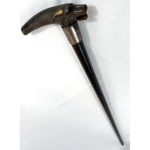 51 - A late 19th Century walking stick with ebony shaft, with silver-mounted carved horn handle, in the f... 