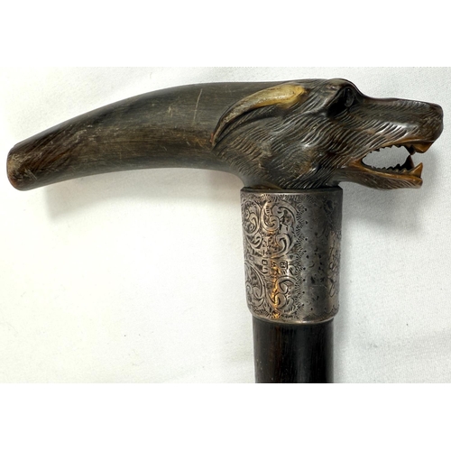 51 - A late 19th Century walking stick with ebony shaft, with silver-mounted carved horn handle, in the f... 