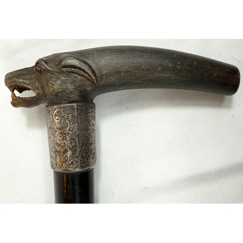 51 - A late 19th Century walking stick with ebony shaft, with silver-mounted carved horn handle, in the f... 