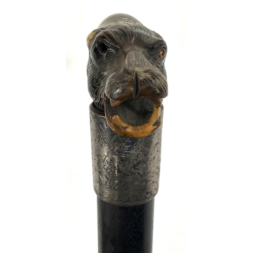 51 - A late 19th Century walking stick with ebony shaft, with silver-mounted carved horn handle, in the f... 