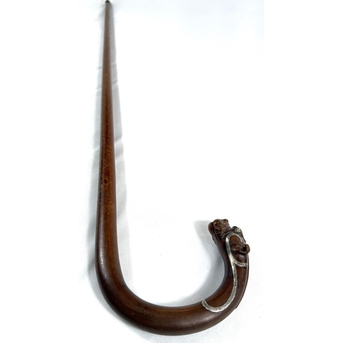 52 - A 19th Century walking stick, the looped handle with finial in the form of a dog's head, silver moun... 