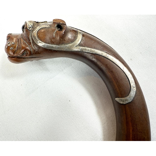 52 - A 19th Century walking stick, the looped handle with finial in the form of a dog's head, silver moun... 