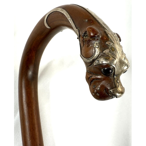 52 - A 19th Century walking stick, the looped handle with finial in the form of a dog's head, silver moun... 