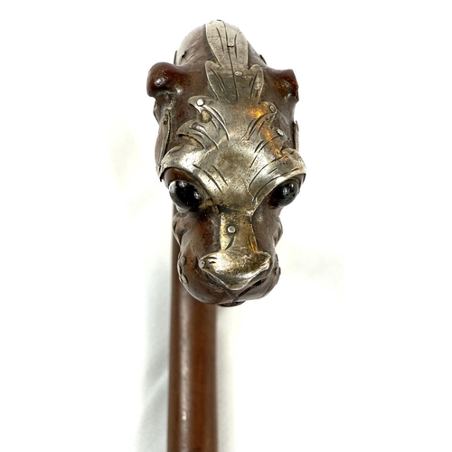 52 - A 19th Century walking stick, the looped handle with finial in the form of a dog's head, silver moun... 